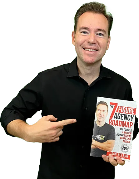 Josh Nelson holding The Seven Figure Agency Roadmap book